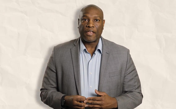 Derik Coffey wearing a light blue shirt and grey jacket